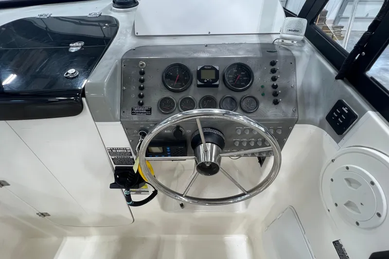 Slide: The Image of 2006 Trophy 2352 WA boat dashboard with steering wheel and instrument panel. - 11