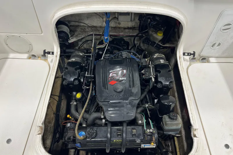 Slide: The Image of Engine compartment of a 2006 Trophy 2352 WA boat, featuring a MerCruiser 5.0 MPI engine. - 19