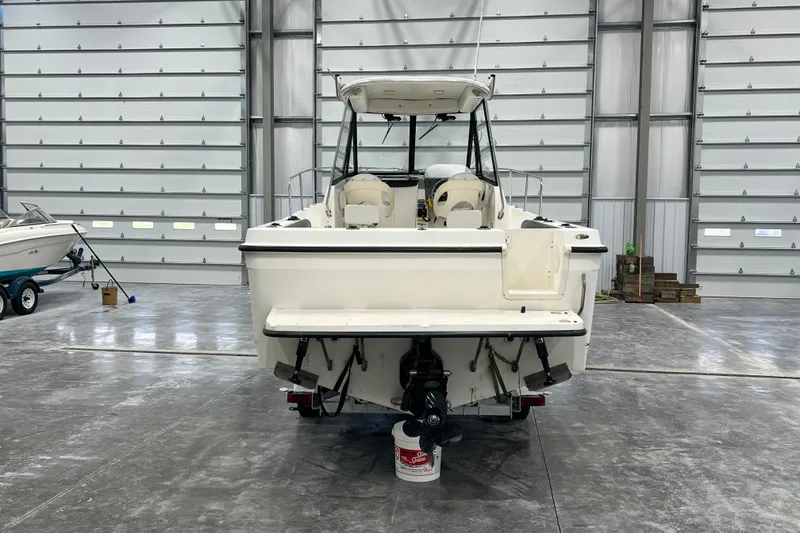 Slide: The Image of 2006 Trophy 2352 WA boat in a spacious indoor storage facility. - 2