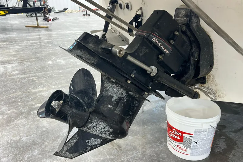 Slide: The Image of 2006 Trophy 2352 WA boat with MerCruiser engine and propeller in a garage setting. - 21