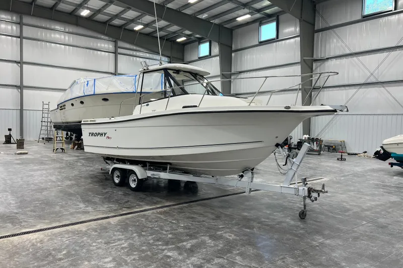 Slide: The Image of 2006 Trophy 2352 WA boat on trailer in spacious indoor storage facility. - 5