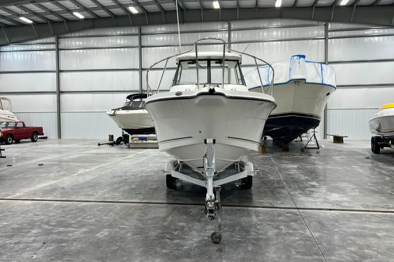 Slide: The Image of 2006 Trophy 2352 WA boat in storage facility, front view, on trailer. - 6