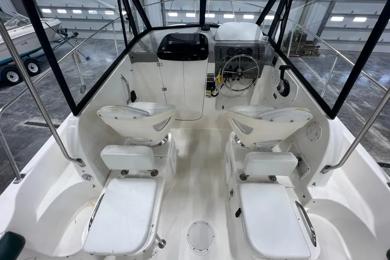 Slide: The Image of Interior view of a 2006 Trophy 2352 WA boat, featuring seating and steering console. - 9