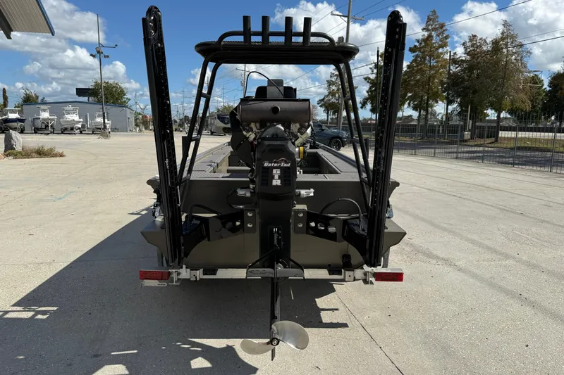 Slide: The Image of 2022 Gator Tail Extreme 1860cc boat, rear view with motor, parked outdoors. - 6