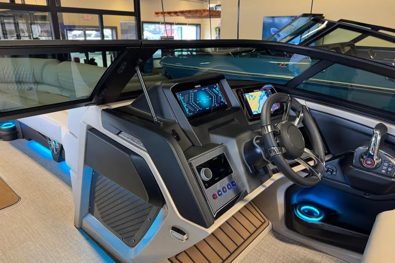 Slide: The Image of 2026 Tahoe Pontoon Grand Tahoe LTD Quad Lounge interior with modern dashboard and steering wheel. - 13