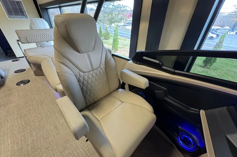 Slide: The Image of Luxurious interior of 2026 Tahoe Pontoon Grand Tahoe LTD Quad Lounge with plush seating. - 14