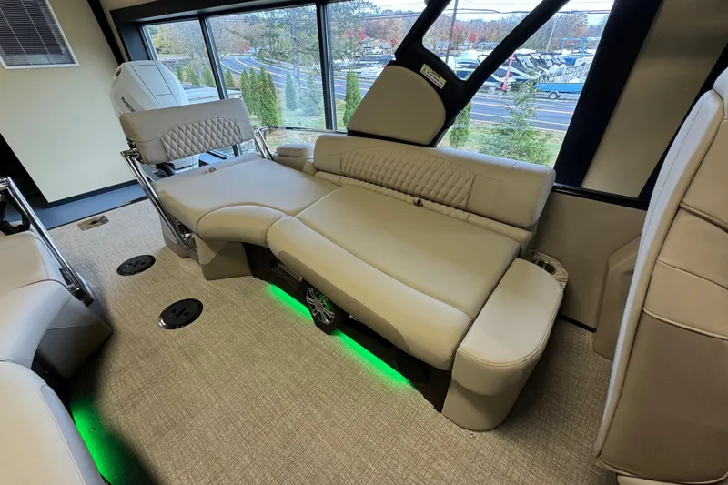 Slide: The Image of 2026 Tahoe Pontoon Grand Tahoe LTD Quad Lounge interior with luxurious seating and ambient lighting. - 19