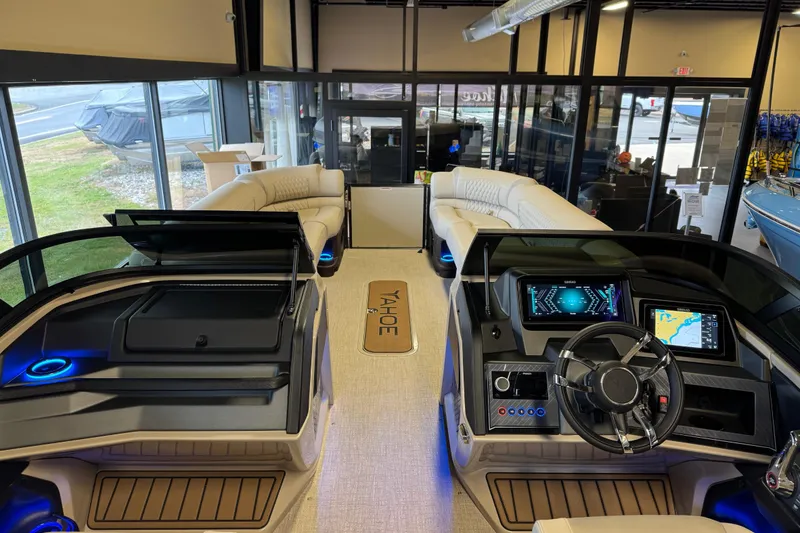 Slide: The Image of 2026 Tahoe Pontoon Grand Tahoe LTD Quad Lounge interior with modern dashboard and plush seating. - 20