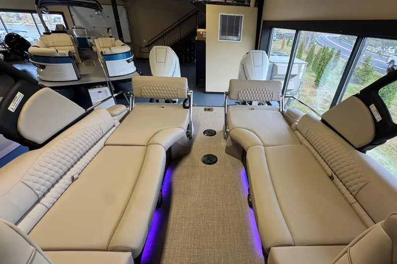 Slide: The Image of 2026 Tahoe Pontoon Grand Tahoe LTD Quad Lounge interior with luxurious seating and ambient lighting. - 21