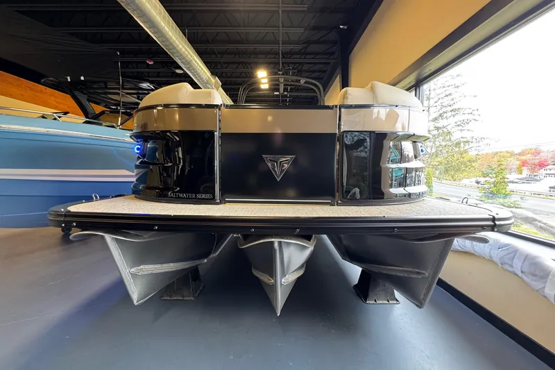 Slide: The Image of 2026 Tahoe Pontoon Grand Tahoe LTD Quad Lounge in showroom, rear view. - 3