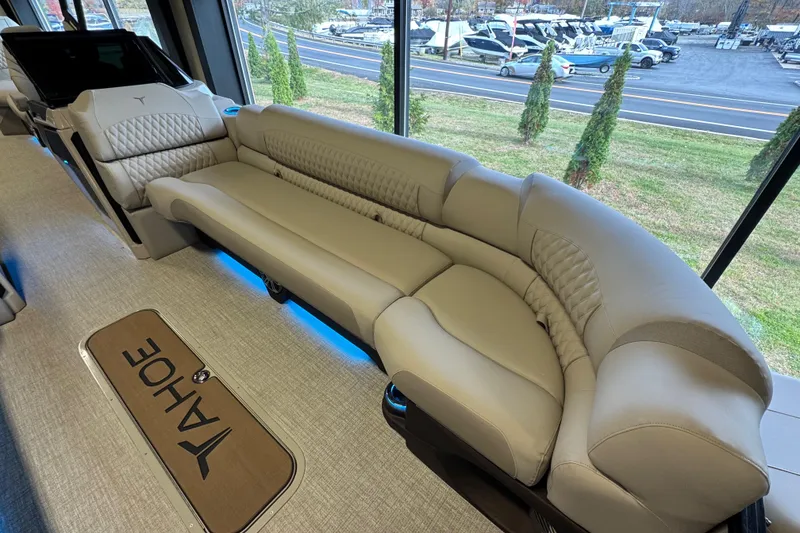 Slide: The Image of Luxurious interior of 2026 Tahoe Pontoon Grand Tahoe LTD Quad Lounge with plush seating. - 6