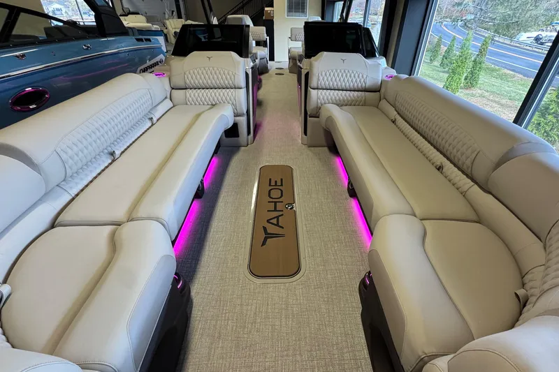 Slide: The Image of Luxurious interior of 2026 Tahoe Pontoon Grand Tahoe LTD Quad Lounge with plush seating and ambient lighting. - 8