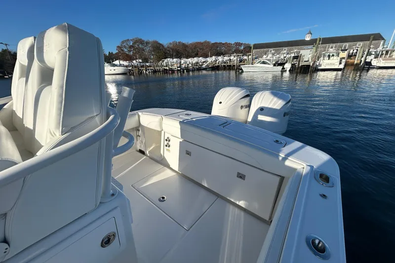 Slide: The Image of 2022 Regulator 25 boat with dual engines docked at a marina under clear blue skies. - 11