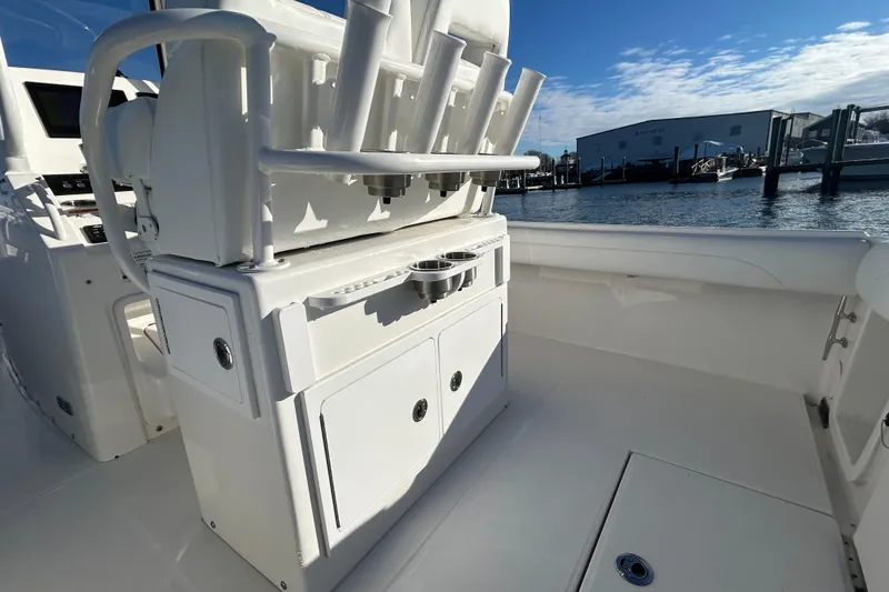 Slide: The Image of 2022 Regulator 25 boat interior with rod holders and storage, dockside view. - 12