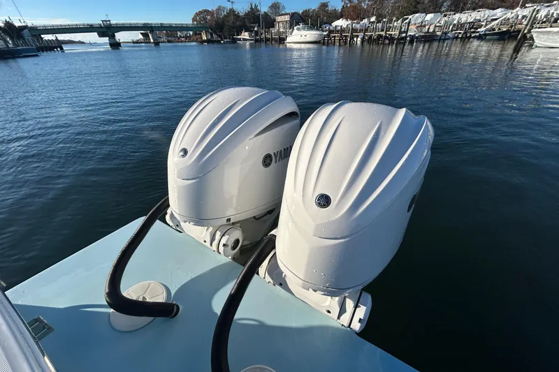 Slide: The Image of Twin Yamaha outboard engines on a 2022 Regulator 25 boat, docked in a marina. - 16