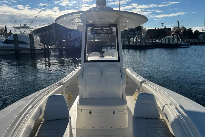 Slide: The Image of 2022 Regulator 25 boat docked, showcasing sleek design and spacious seating. - 18