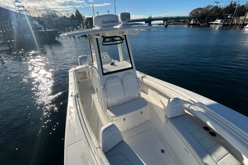 Slide: The Image of 2022 Regulator 25 boat on calm water, featuring Garmin equipment. - 19
