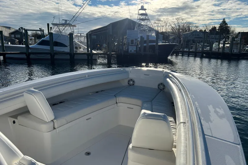Slide: The Image of 2022 Regulator 25 boat docked in a marina under a partly cloudy sky. - 20