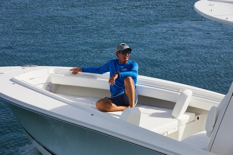 Slide: The Image of 2022 Regulator 25 boat interior with helm, steering wheel, and navigation screens. - 6