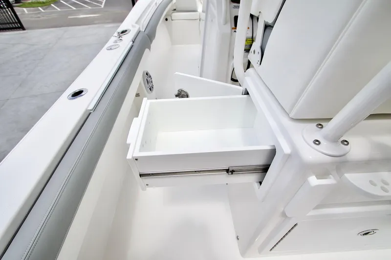 Slide: The Image of 2022 Regulator 25 boat interior with white seating, docked at a marina. - 9