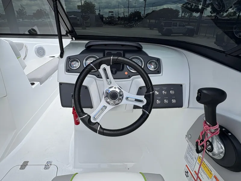 Slide: The Image of 2019 Tahoe 700 boat dashboard with steering wheel and control panel. - 12
