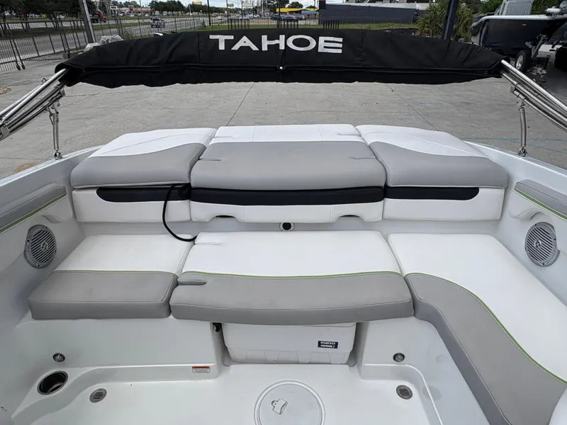 Slide: The Image of 2019 Tahoe 700 boat interior with cushioned seating and canopy. - 13