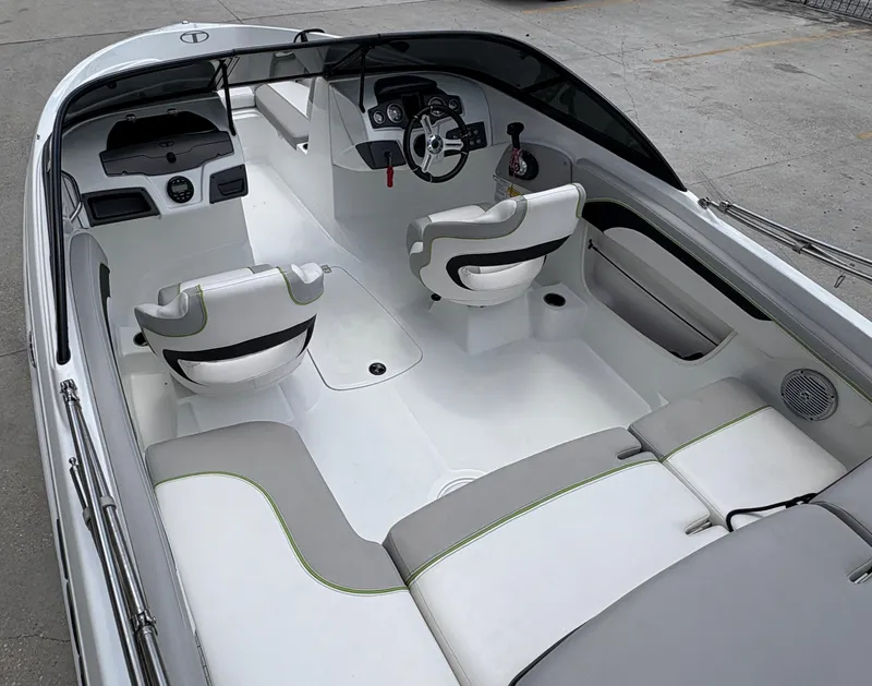 Slide: The Image of 2019 Tahoe 700 boat interior with white and gray seating, steering wheel, and dashboard. - 7