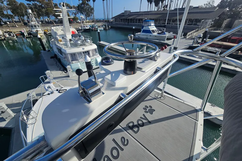 Slide: The Image of 2003 Topaz 32 Express boat docked at marina, view from helm station. - 13