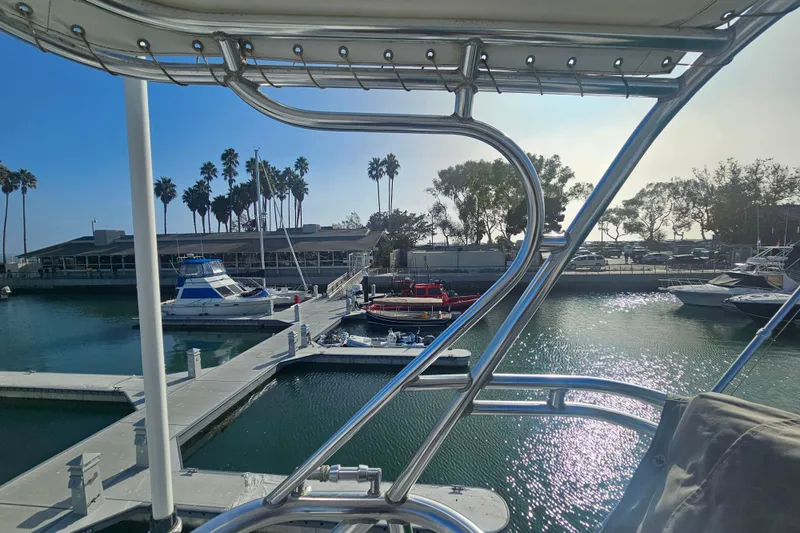 Slide: The Image of Marina view from 2003 Topaz 32 Express boat, featuring docked vessels and palm trees. - 14