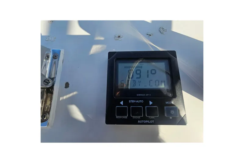 Slide: The Image of Simrad AP11 autopilot display on 2003 Topaz 32 Express boat dashboard. - 17