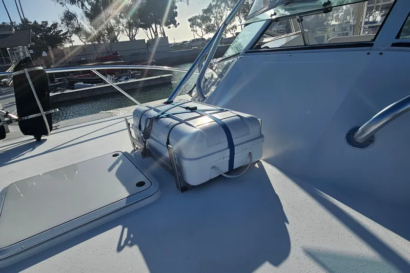 Slide: The Image of 2003 Topaz 32 Express boat deck with secured white storage box. - 2