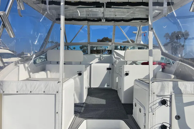 Slide: The Image of 2003 Topaz 32 Express boat interior with white seating and clear canopy. - 20