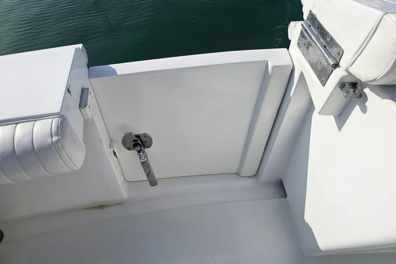 Slide: The Image of 2003 Topaz 32 Express boat interior with white seating and latch detail. - 22