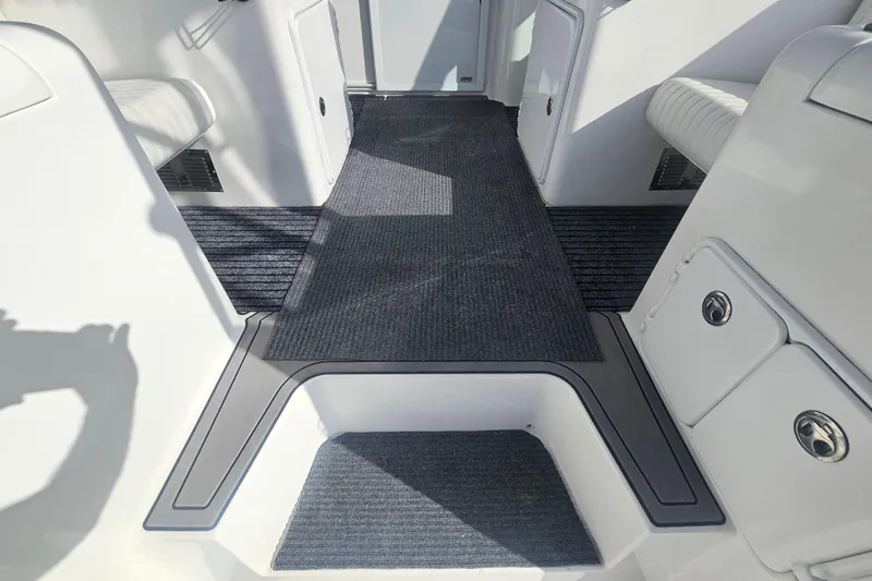 Slide: The Image of Interior view of 2003 Topaz 32 Express boat with carpeted flooring and seating. - 25