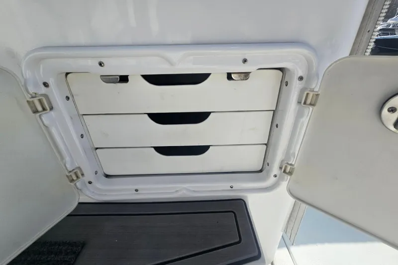 Slide: The Image of Storage compartment with three drawers on a 2003 Topaz 32 Express boat. - 29