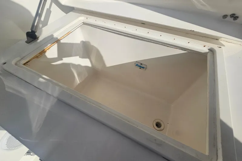 Slide: The Image of Open storage compartment on 2003 Topaz 32 Express boat, featuring a clean interior. - 30