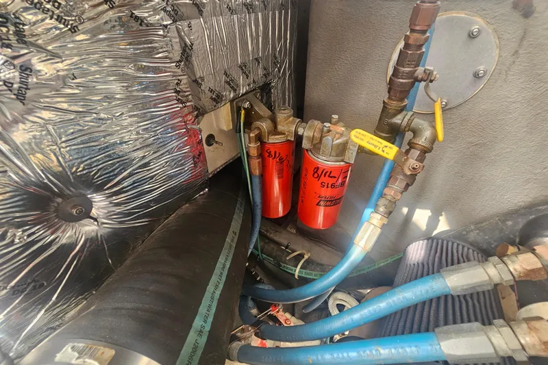 Slide: The Image of Engine compartment of 2003 Topaz 32 Express with fuel filters and insulated wiring. - 34