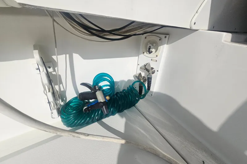 Slide: The Image of Coiled hose and fittings on 2003 Topaz 32 Express boat deck. - 35