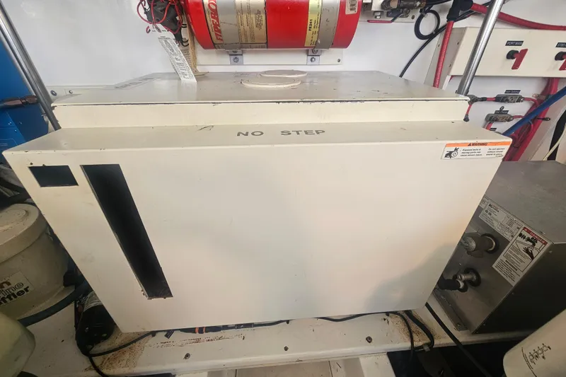 Slide: The Image of Engine room of 2003 Topaz 32 Express boat with equipment and safety labels. - 36