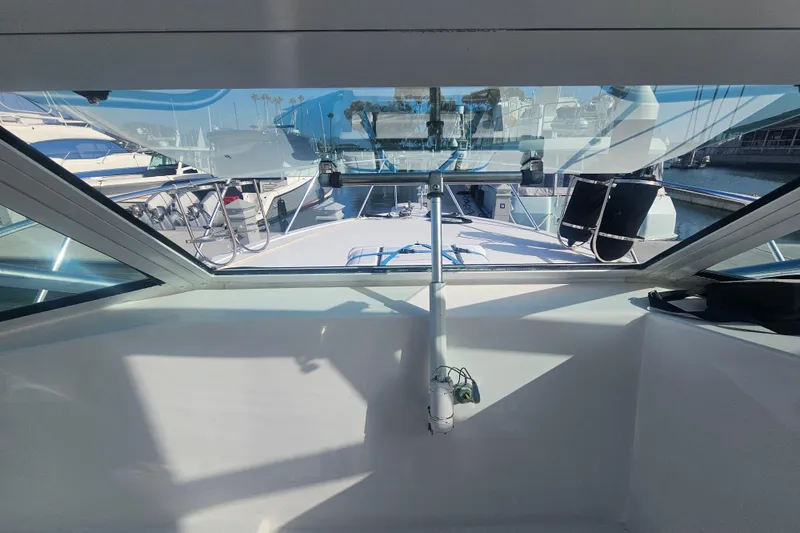 Slide: The Image of View from the helm of a 2003 Topaz 32 Express boat in a marina. - 42