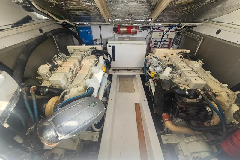 Slide: The Image of Engine room of 2003 Topaz 32 Express boat, featuring dual engines and equipment. - 43