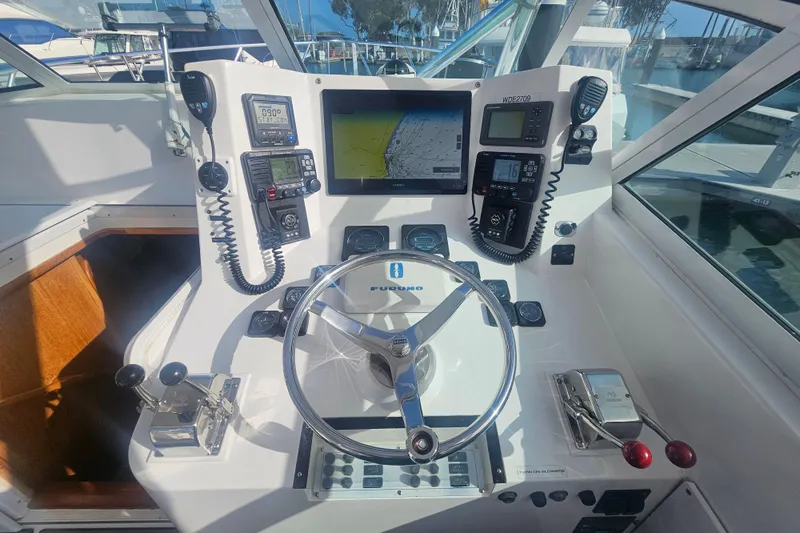 Slide: The Image of Helm of 2003 Topaz 32 Express boat with navigation equipment and steering wheel. - 45