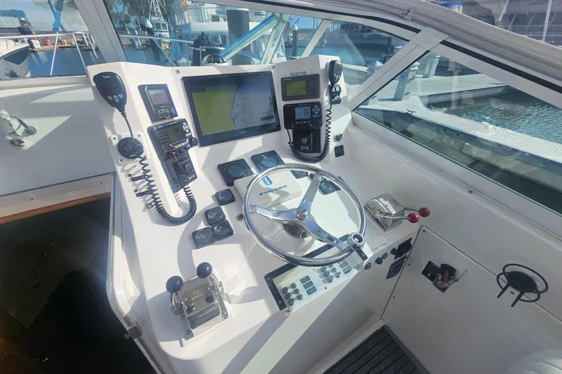 Slide: The Image of Cockpit of 2003 Topaz 32 Express boat with navigation equipment and steering wheel. - 46