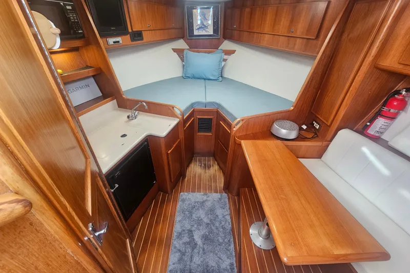 Slide: The Image of Interior of 2003 Topaz 32 Express boat with wood finish and compact amenities. - 47