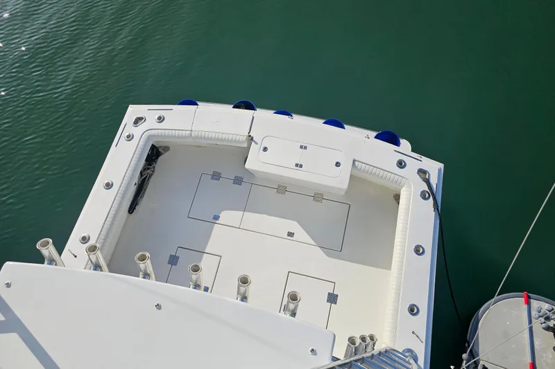 Slide: The Image of Top view of 2003 Topaz 32 Express boat deck, featuring rod holders and storage compartments. - 5