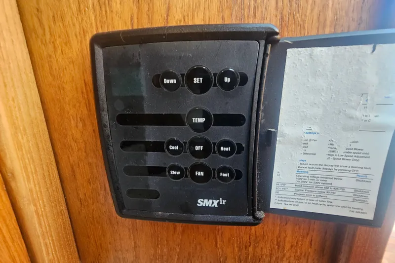 Slide: The Image of SMXir control panel on 2003 Topaz 32 Express boat, mounted on wooden surface. - 50