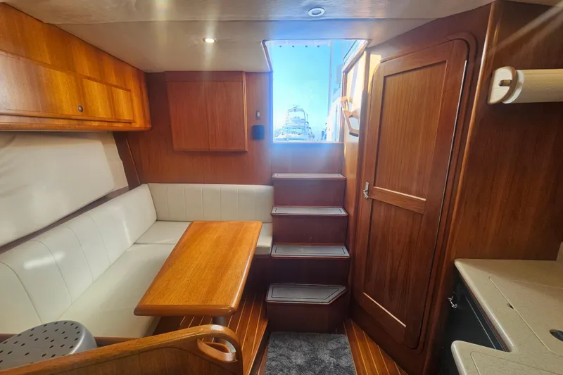 Slide: The Image of Interior of 2003 Topaz 32 Express boat with wooden finishes and seating area. - 52