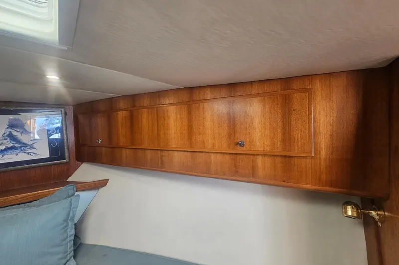 Slide: The Image of Wooden interior cabin of 2003 Topaz 32 Express boat with artwork and cushions. - 54