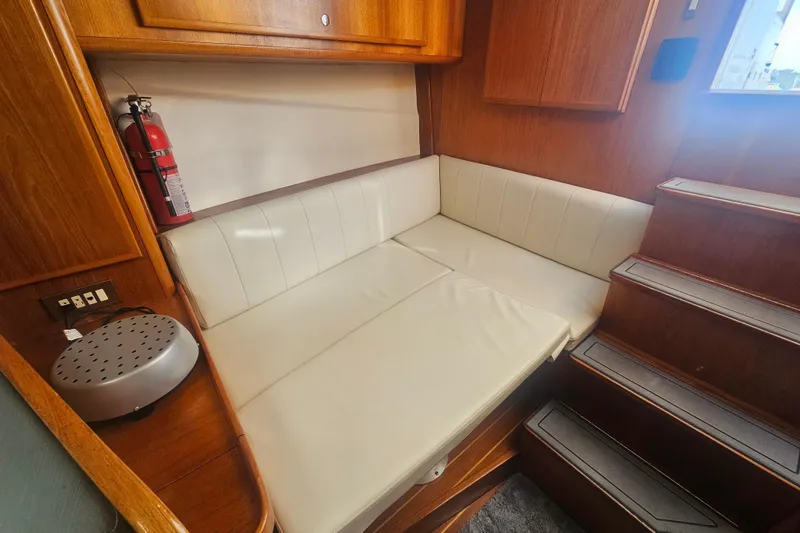 Slide: The Image of 2003 Topaz 32 Express cabin interior with white seating and wooden accents. - 56