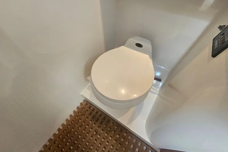 Slide: The Image of Toilet in 2003 Topaz 32 Express boat with wooden floor mat. - 58